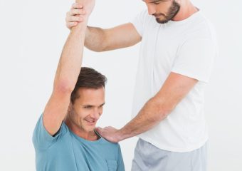 physical-therapist-assisting-man-with-stretching-exercises